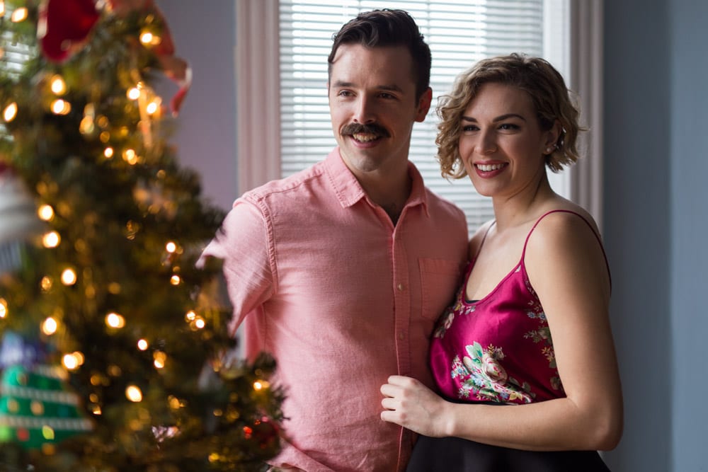 couple in front of holiday Christmas tree