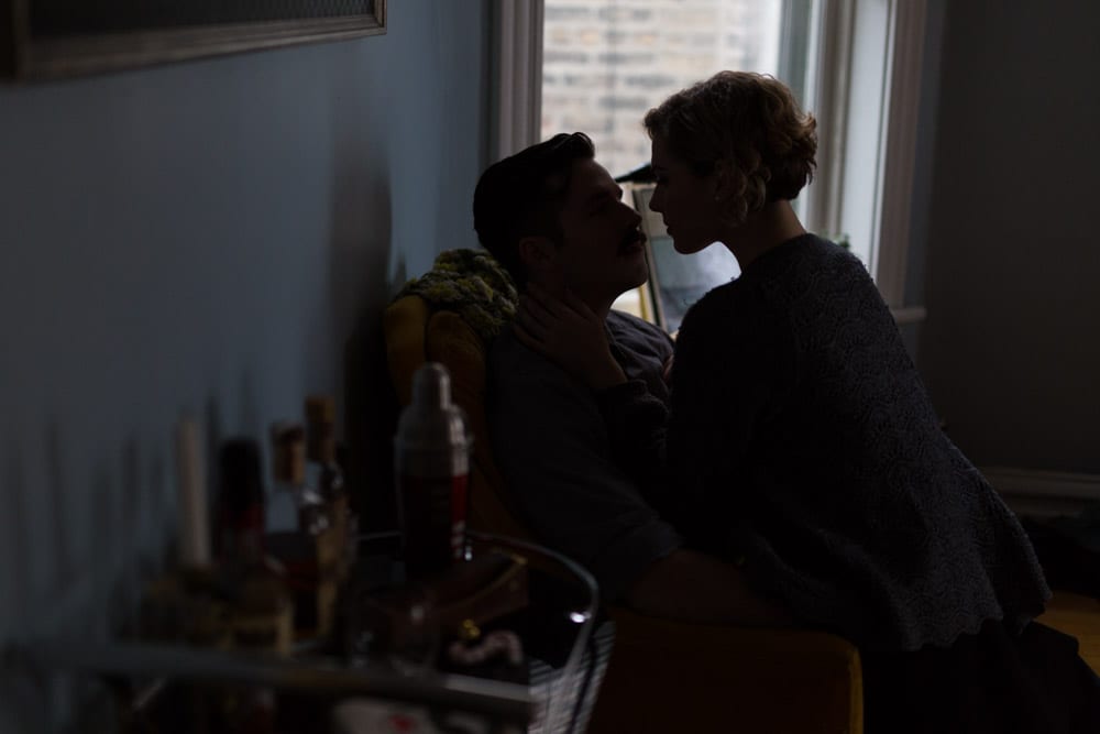 couple kissing in the dark in chair