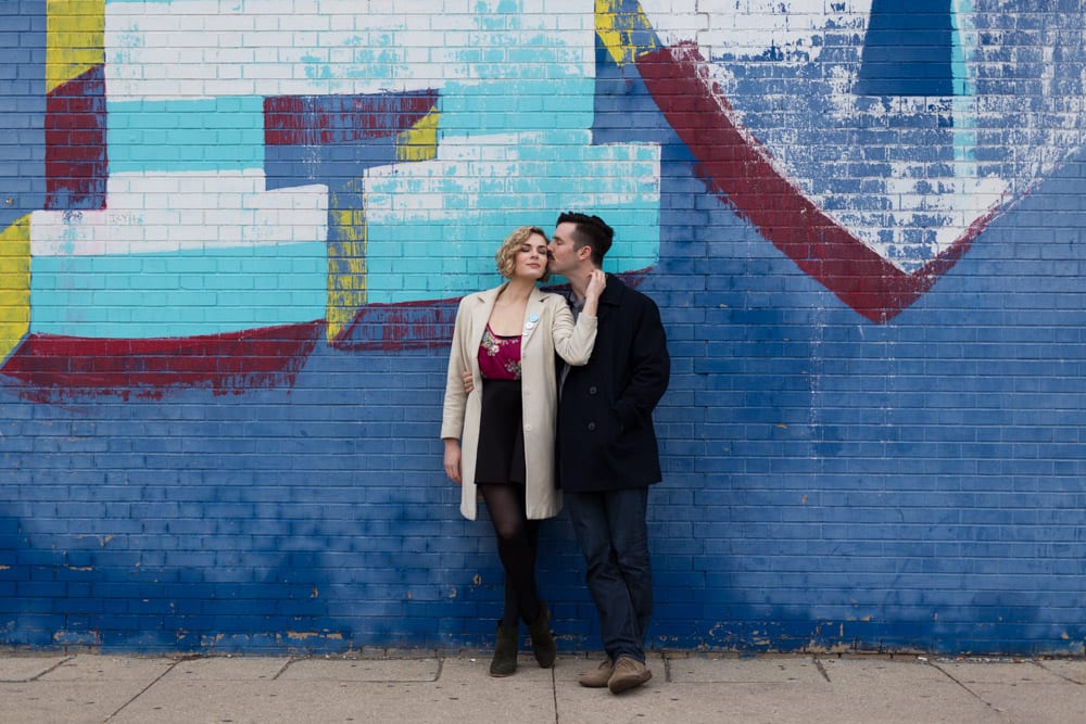 couple hanging out by mural wall