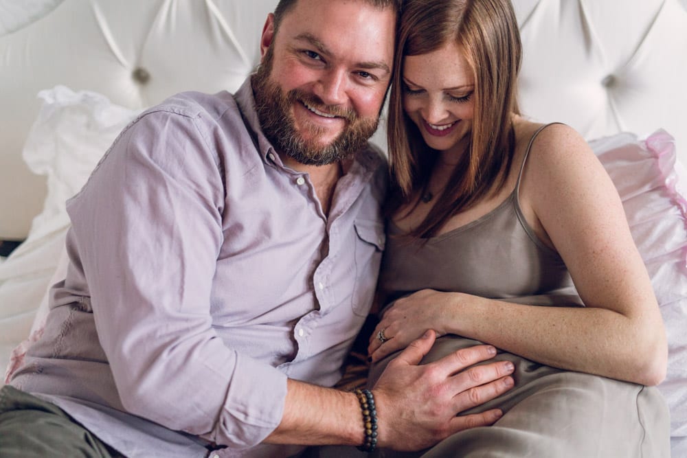 photo of expecting couple on bed