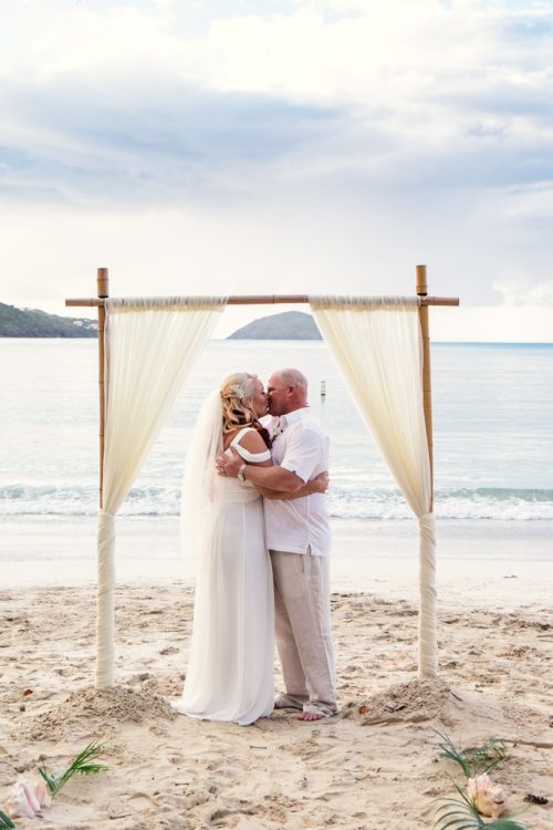 Bride and groom's first kiss on beach during sunset Virgin Islands elopement