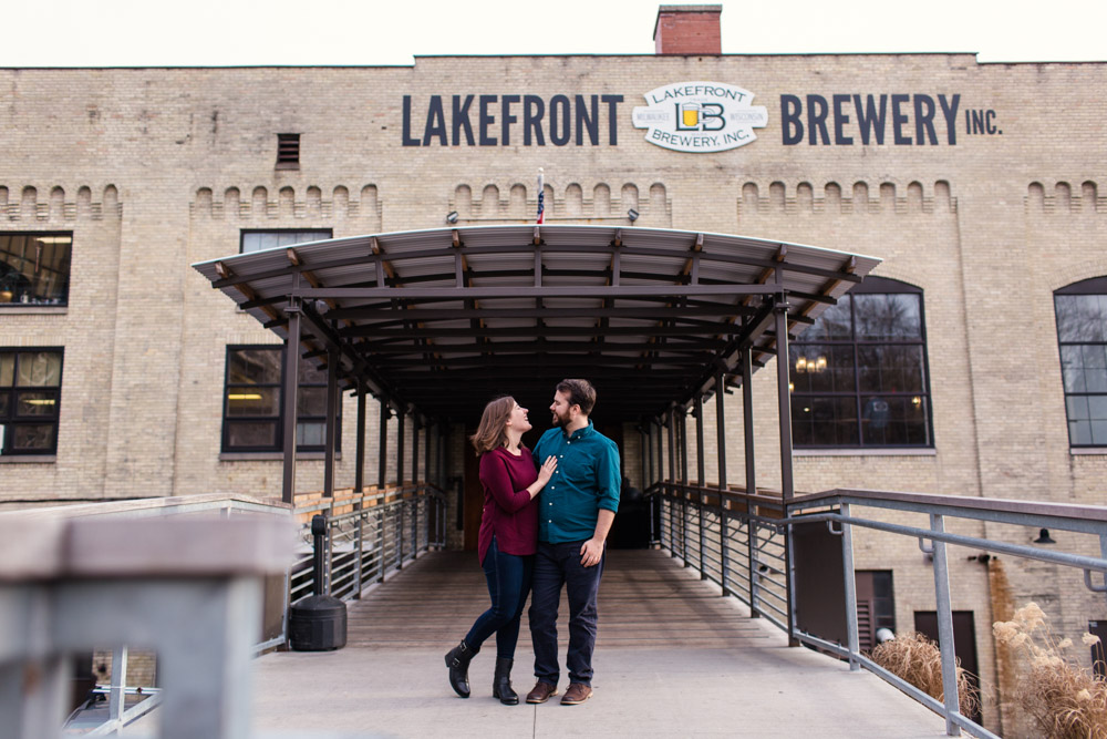 Lakefront Brewery engagement photo of couple in front of Milwaukee brewery entrance