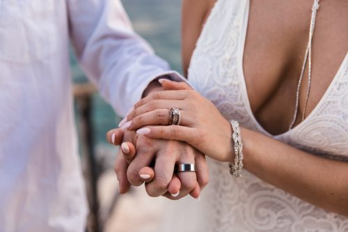 Bride and groom show off their wedding rings at Isla Mujeres destination wedding