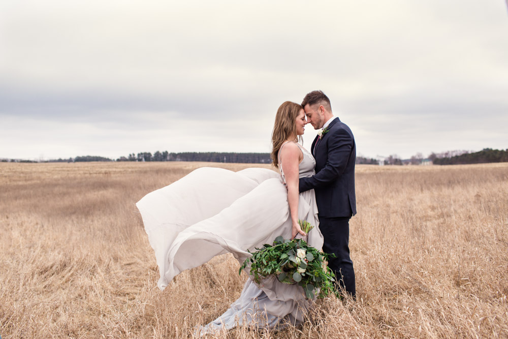 Wisconsin wedding styled shoot at Waupaca barn in fall field with wind blowing dress