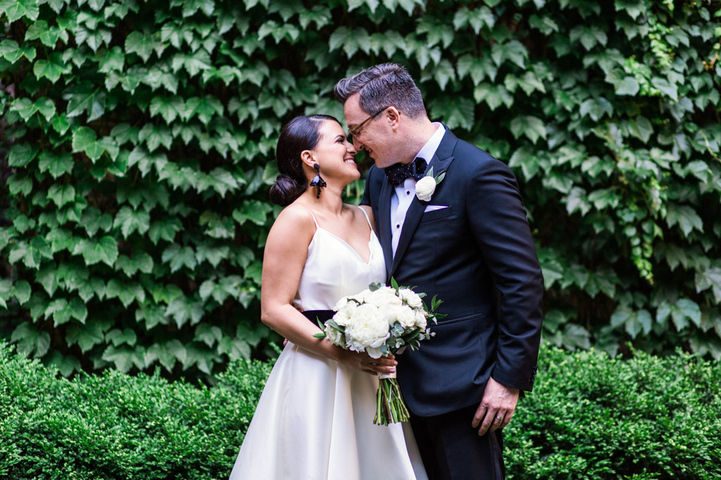 Romantic photo of bride and groom with ivy wall at their Ivy Room Chicago wedding