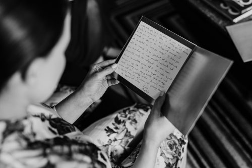 Bride reads love letter from groom at hotel before Ivy Room Chicago wedding