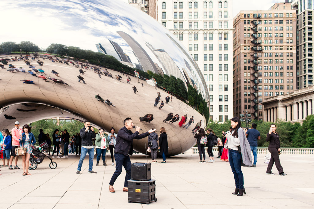 Man serenades girlfriend in front of Cloud Gate during Millennium Park surprise proposal with karaoke and live brass band