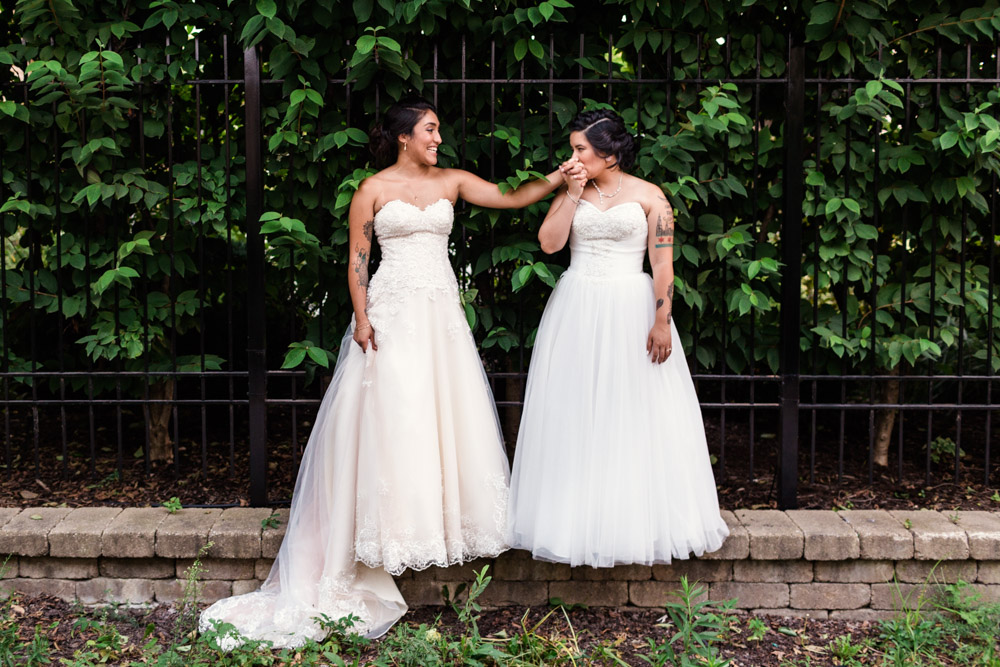 Newlywed brides kiss after their summer Chicago loft wedding at Concord Fifty Five