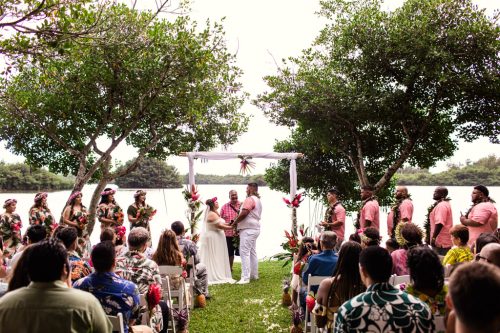 Bride and groom stand during intimate Kualoa Ranch wedding ceremony in Hawaii