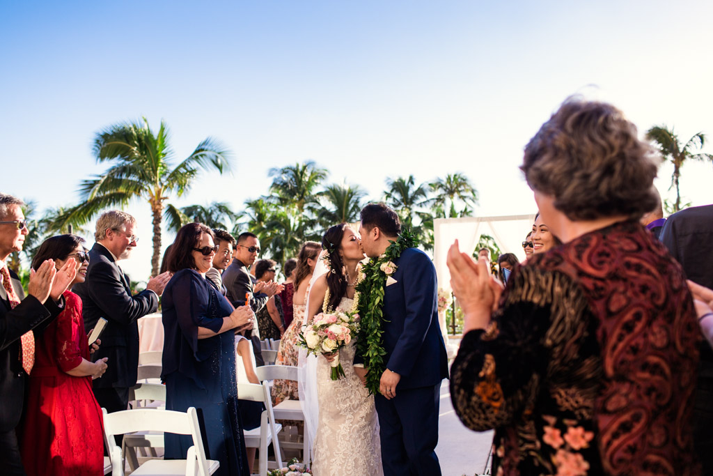 Bride and groom kiss after their Hawaii destination wedding ceremony at Hyatt Regency Waikiki