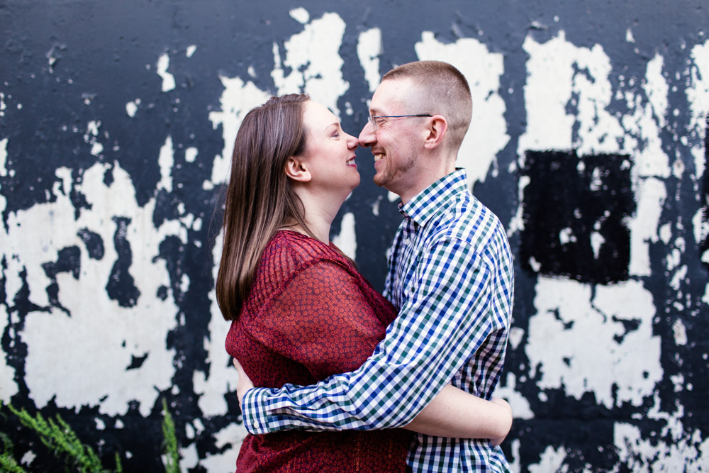 Candid Chicago neighborhood engagement photo in alley outside couple's favorite Chicago brewery