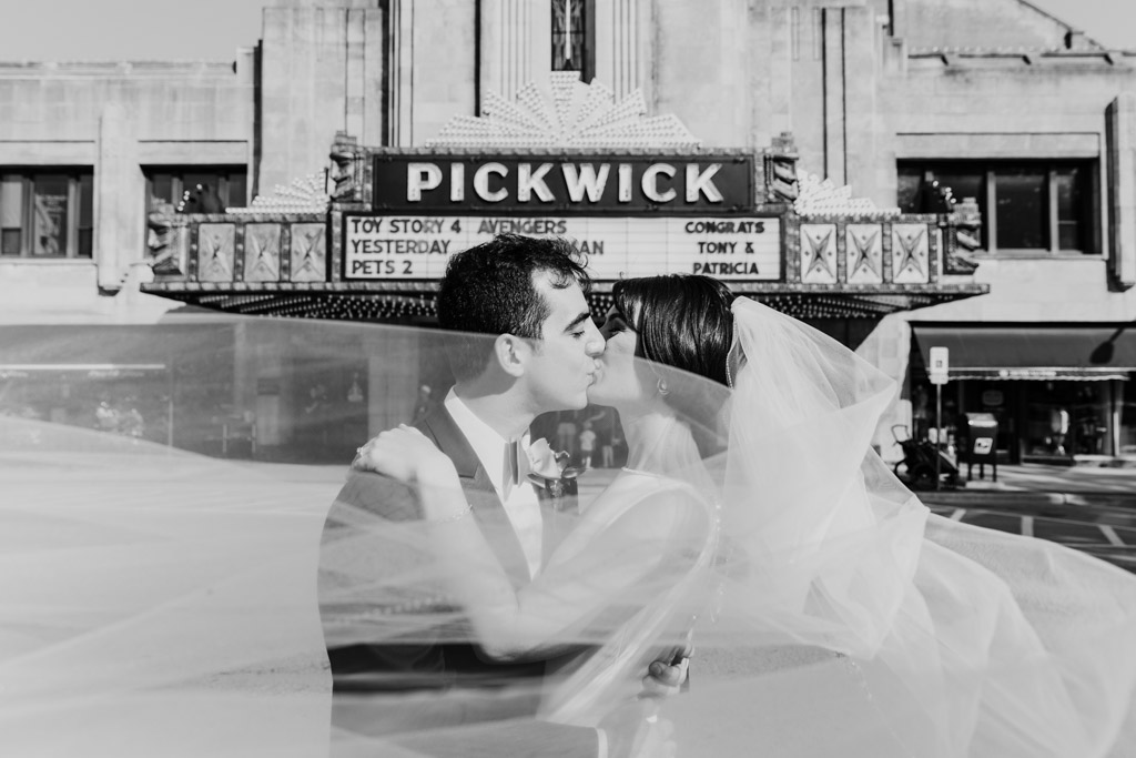 Bride and groom at Pickwick Theatre where they first met with custom wedding day marquee