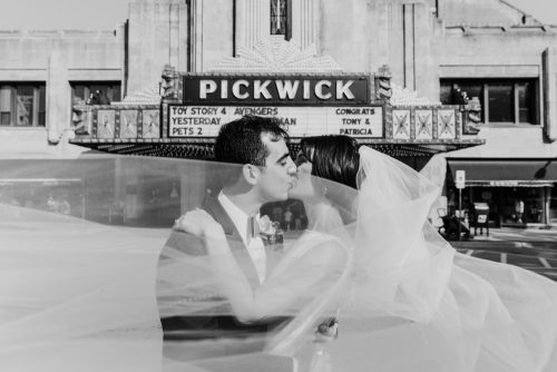 Bride and groom at Pickwick Theatre where they first met with custom wedding day marquee