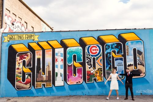 Just married bride and groom with the Greetings From Chicago mural moments after their courthouse elopement