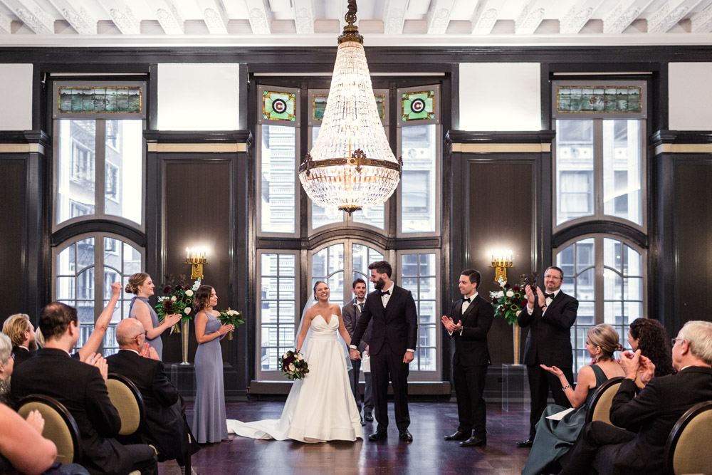 Happy bride and groom at their Chicago Athletic Association wedding ceremony in Madison Room