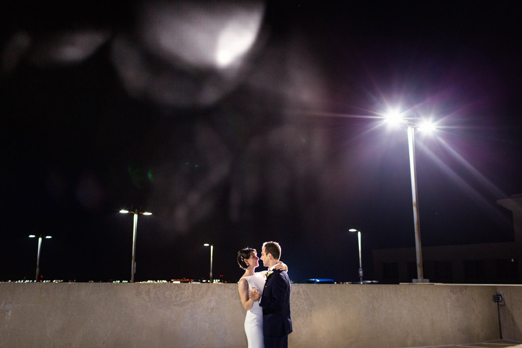 Romantic late night wedding photo of bride and groom dancing on rooftop of Loews Chicago hotel