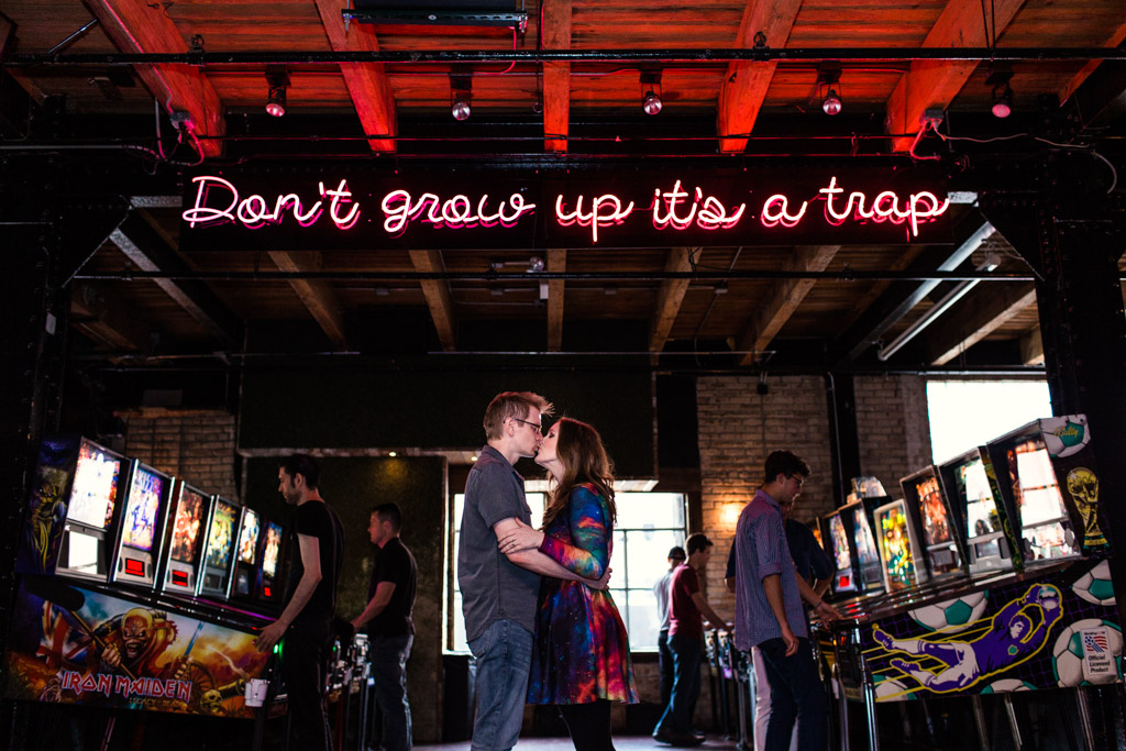 Headquarters Beercade engagement Chicago arcade engagement session with neon sign Don't Grow Up it's a Trap