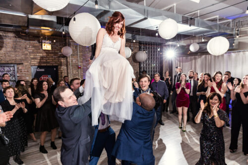 Happy bride in chair at Chicago Jewish wedding at Floating World Gallery