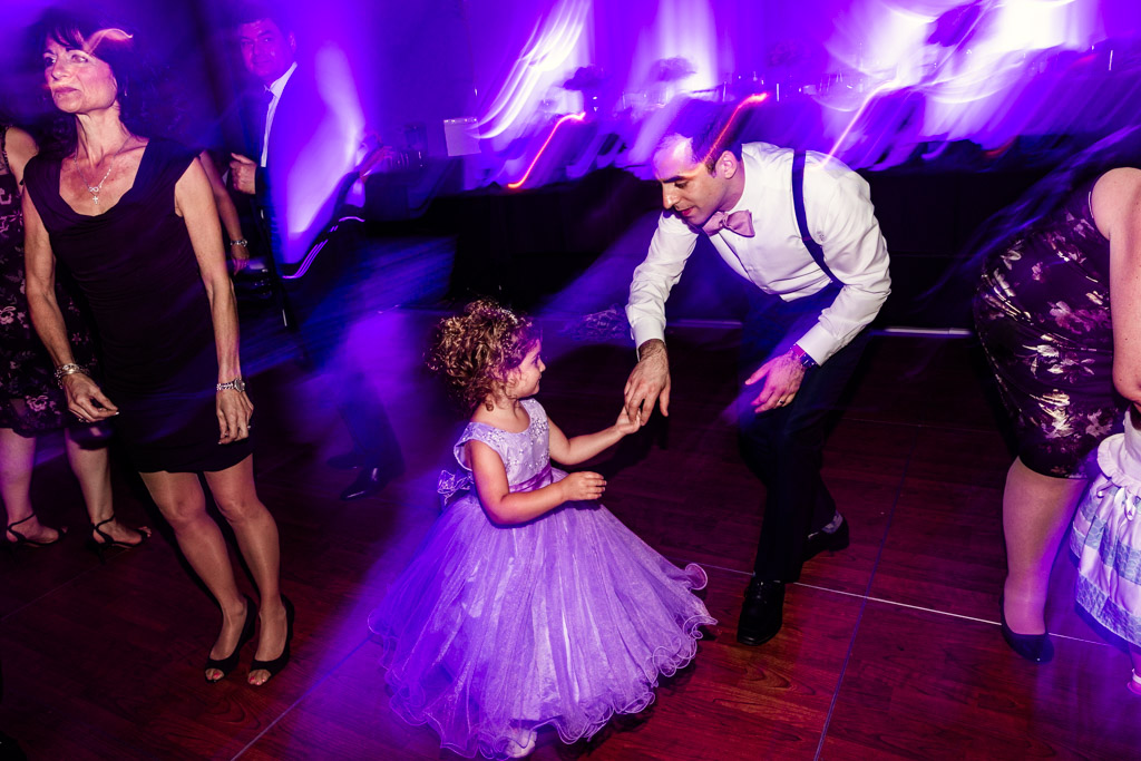 Groom and flower girl dance during Loews Chicago wedding reception