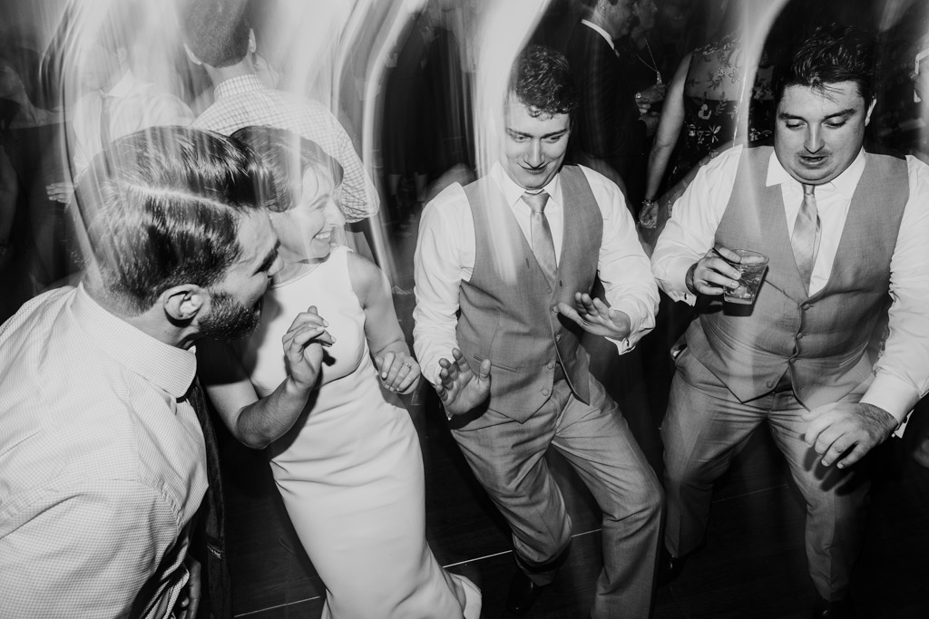 Bride and groomsmen on dance floor during Loews Chicago wedding reception