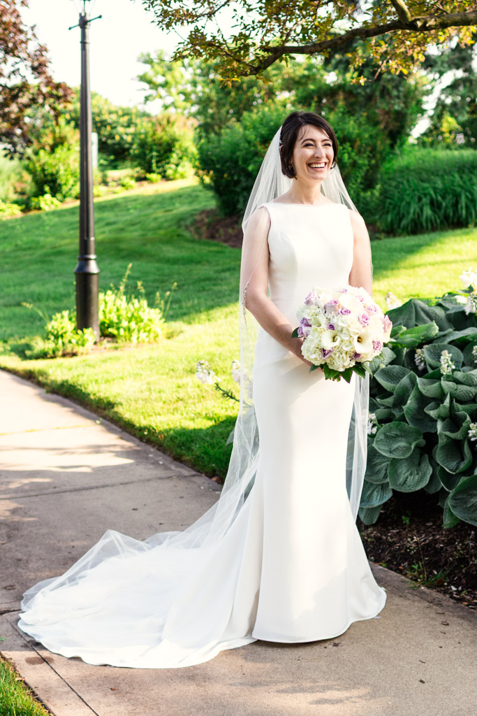 Portrait of bride laughing in garden before Loews Chicago hotel wedding reception