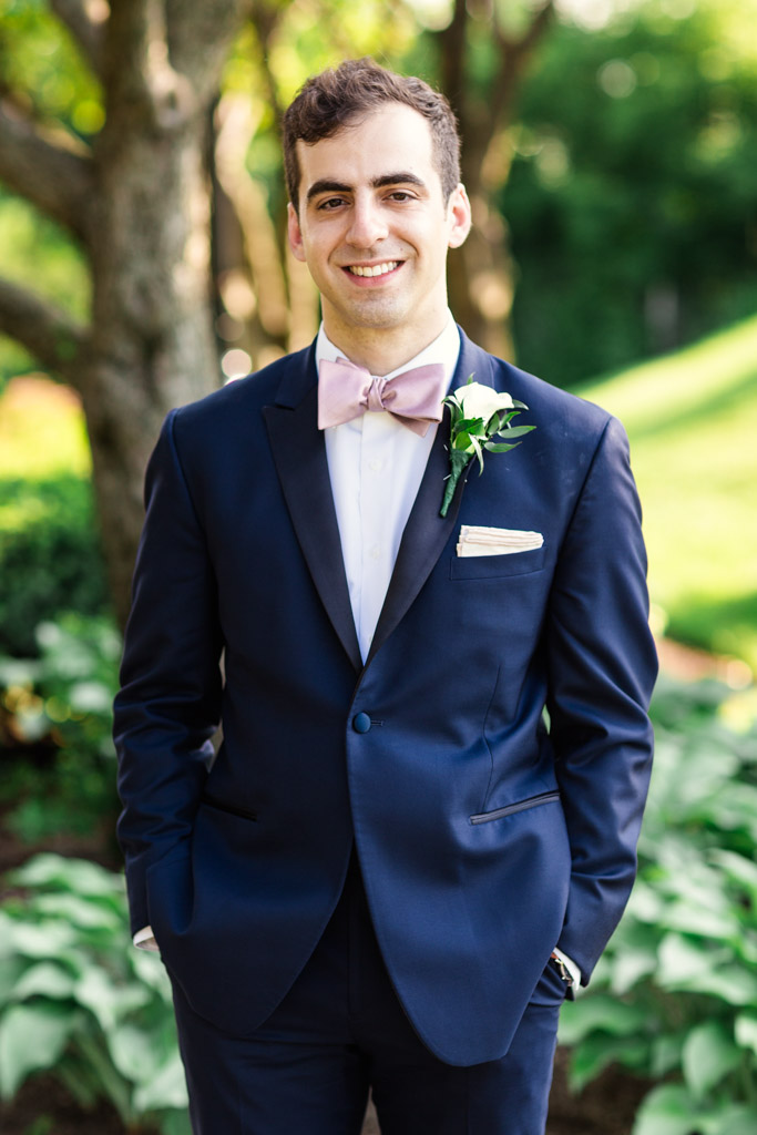 Portrait of summer groom in garden before Loews Chicago hotel wedding reception