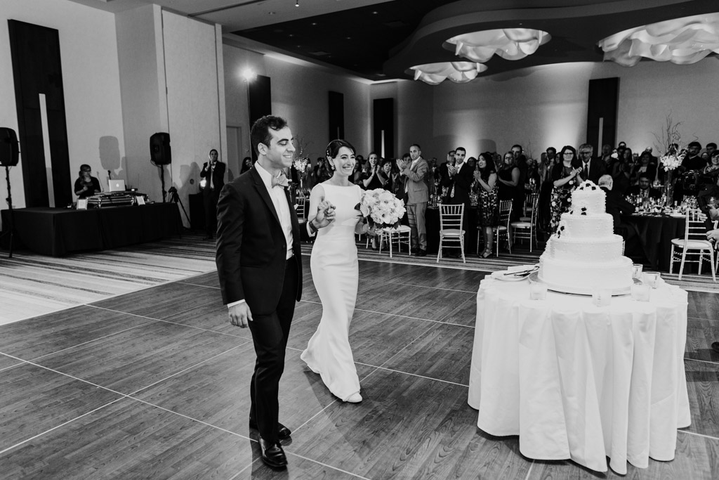 Happy bride and groom enter their Loews Chicago wedding reception