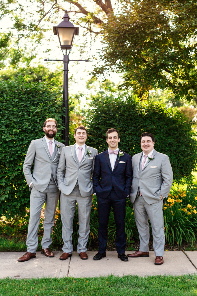Stylish groom and groomsmen in light gray and navy at summer Loews Chicago wedding