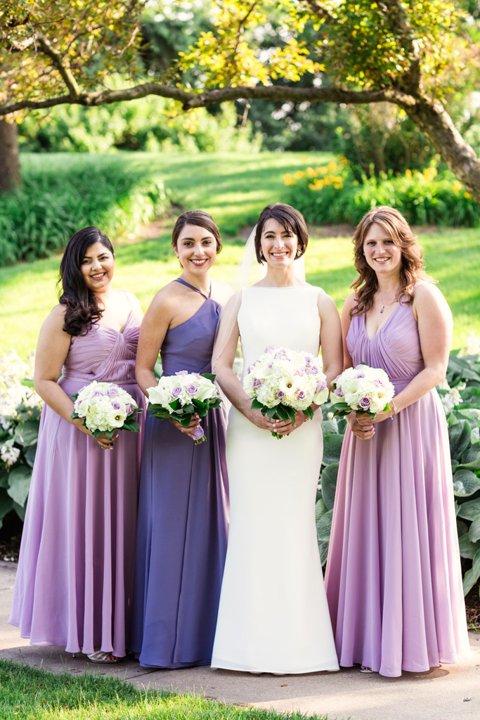 Summer bride and bridesmaids in lavender and blue at summer Loews Chicago wedding