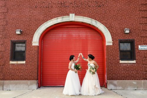 Newlywed Chicago brides dancing outside of their summer Concord Fifty-Five wedding