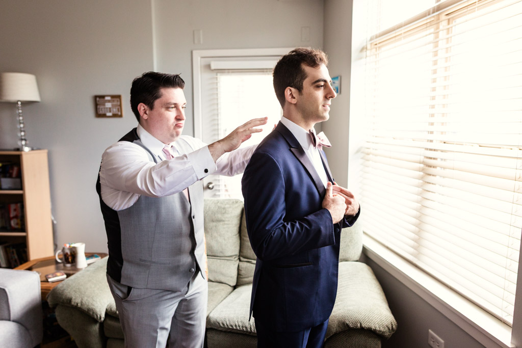 Groom and Best Man getting ready at home before Chicago Greek Orthodox wedding ceremony