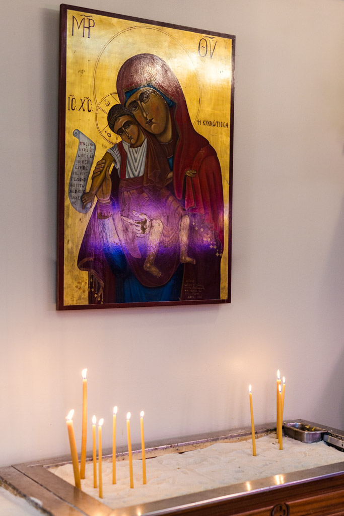 Candles lit in sand box before Chicago Greek Orthodox wedding ceremony at St. George