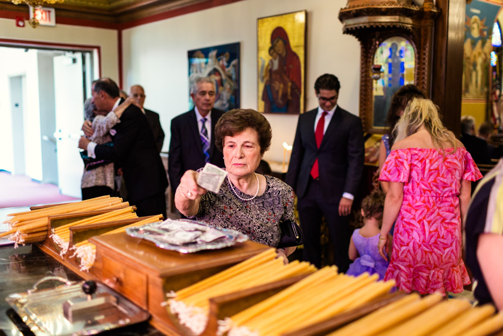 Guests donate dollar bills before Chicago Greek Orthodox wedding ceremony at St. George in Lincoln Park