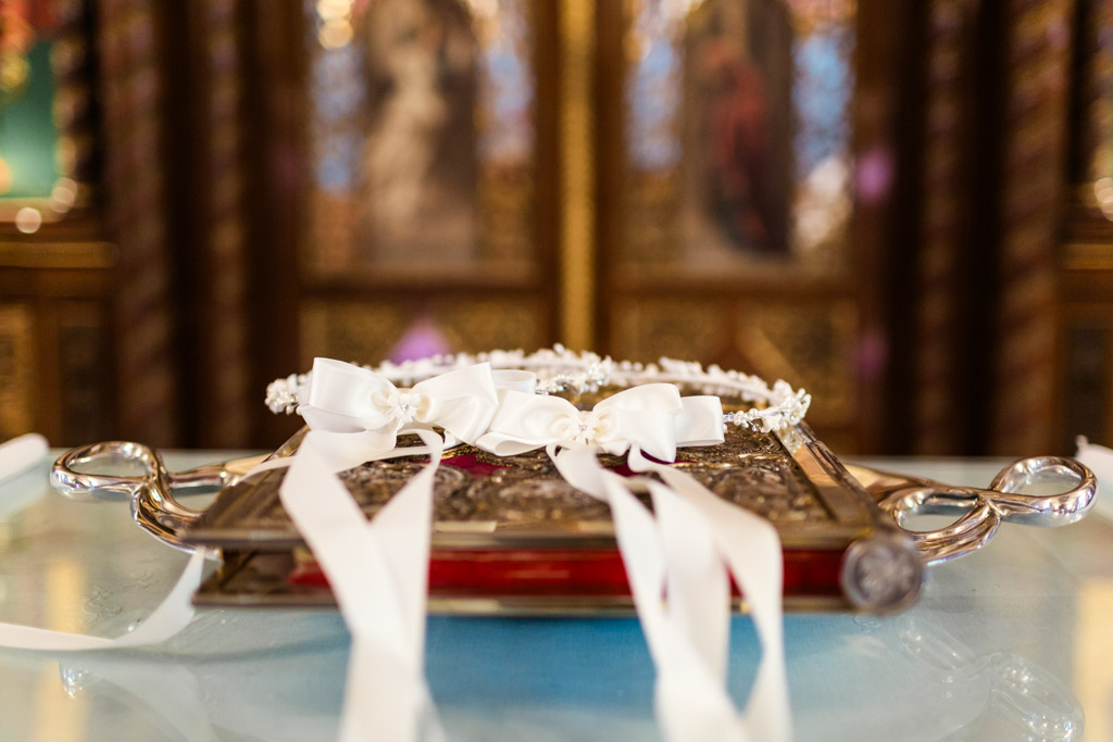 White crown stefana and holy book Greek Orthodox wedding details at St. George church in Chicago