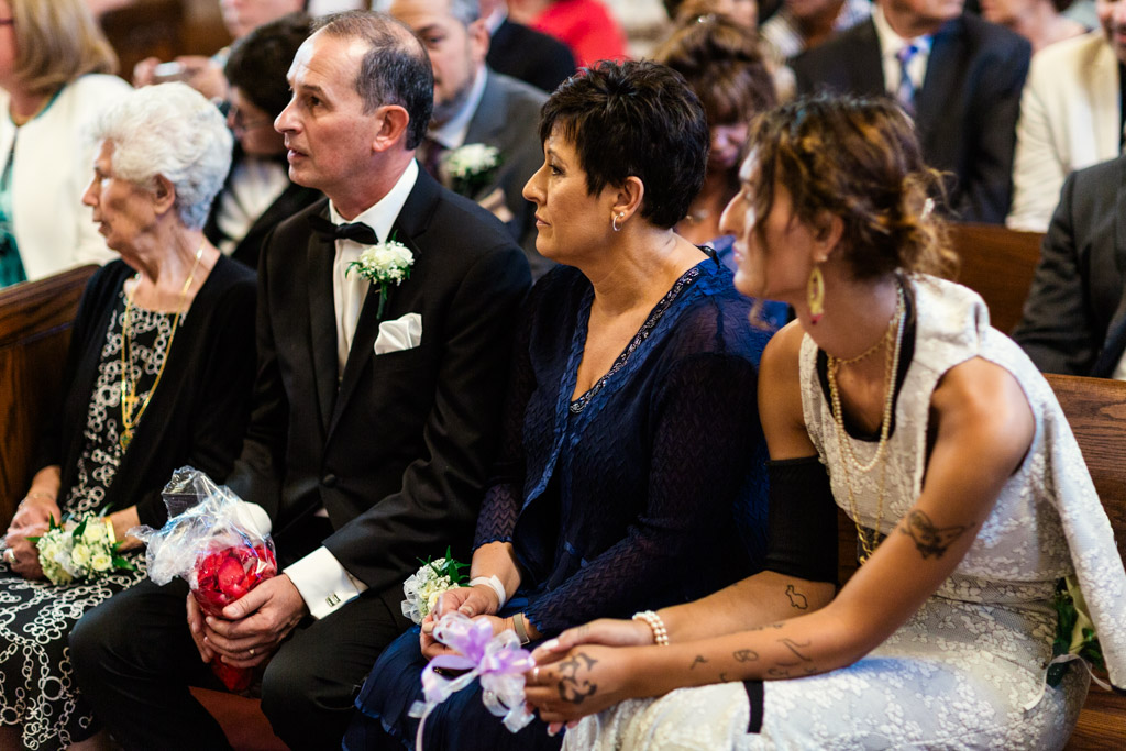 Bride's family in pew during Chicago Greek Orthodox wedding ceremony at St. George in Lincoln Park