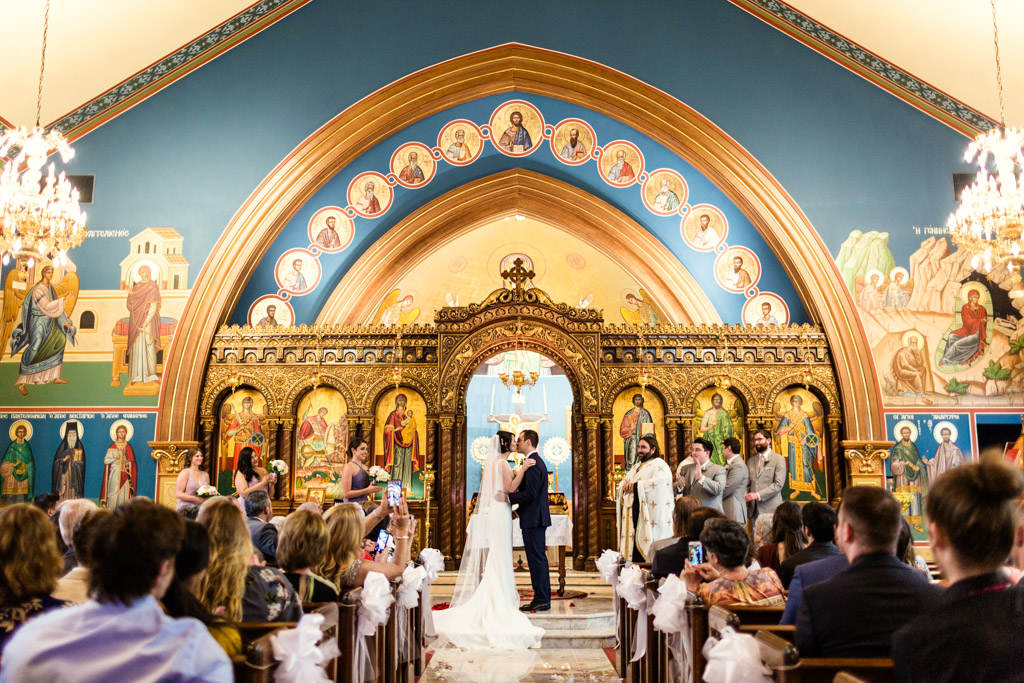 Bride and groom's first kiss at St. George Greek Orthodox church in Lincoln Park, Chicago