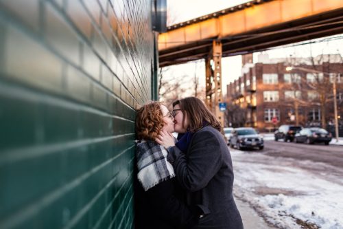 Romantic Chicago winter engagement photo in Wicker Park with green wall and train tracks