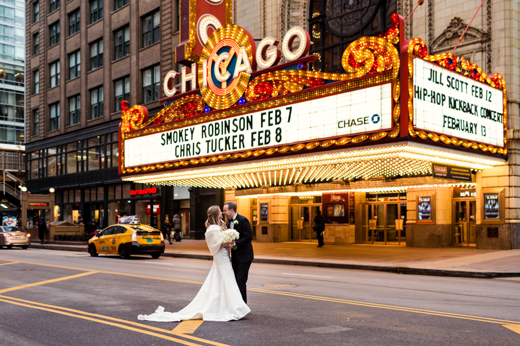 Bride and groom in front of CHICAGO Theatre on State Street at their Renaissance Chicago Downtown wedding