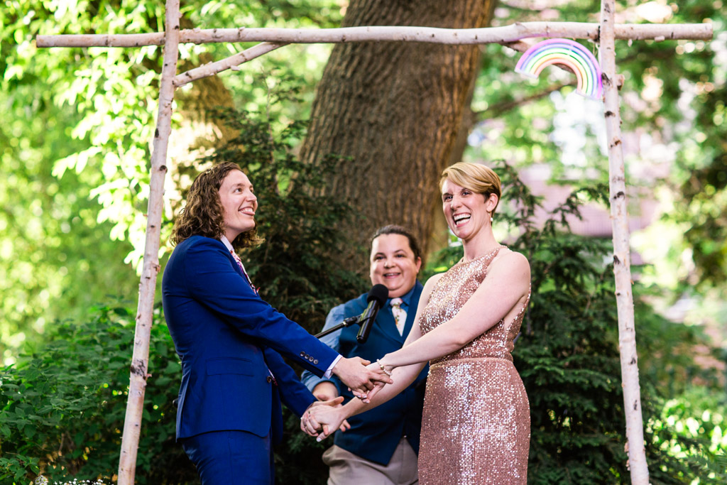 Couple smiles at guests during their summer Firehouse Chicago wedding ceremony