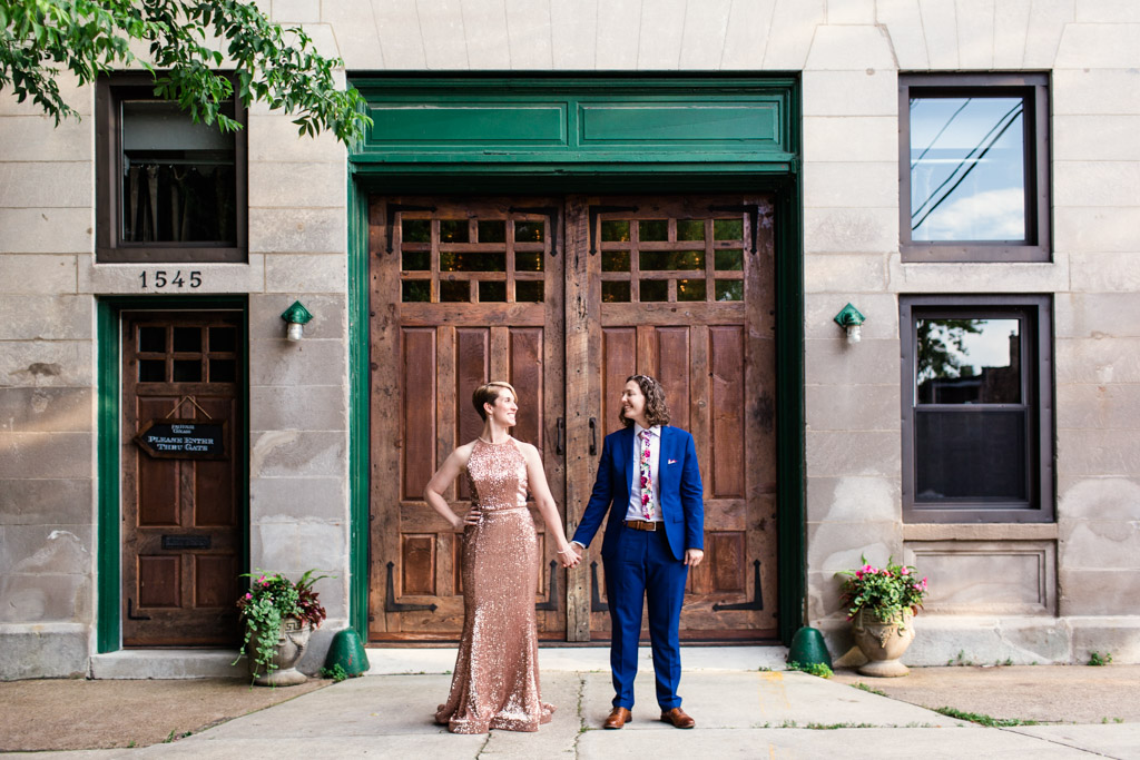 Couple holds hands in front of Firehouse Chicago wedding venue