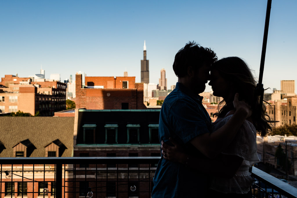 Romantic summer engagement photo at couple's home with Chicago skyline