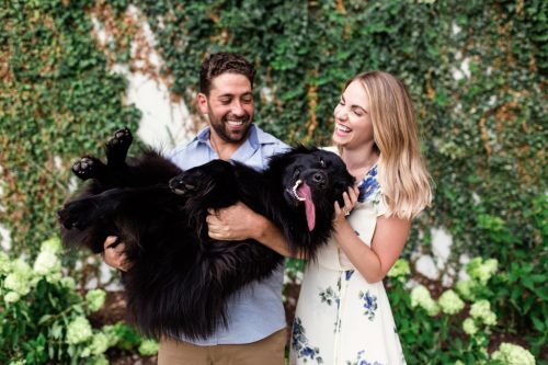 Candid family photo of couple with their happy dog during summer Chicago engagement session