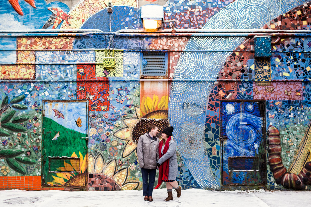 Winter Chicago neighborhood engagement photo of couple in Rogers Park with colorful mural