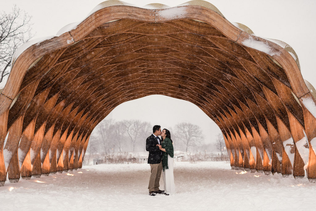 Bride and groom kiss under honeycomb in the snow during their Chicago winter minimony