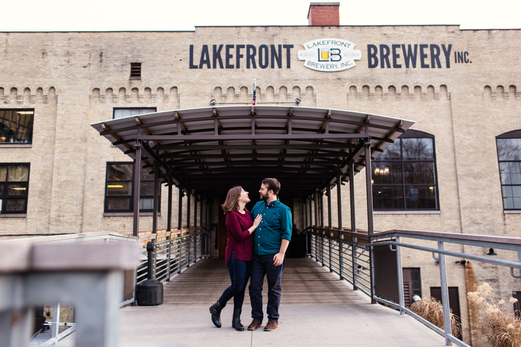 Candid Lakefront Brewery engagement photo in Milwaukee, Wisconsin