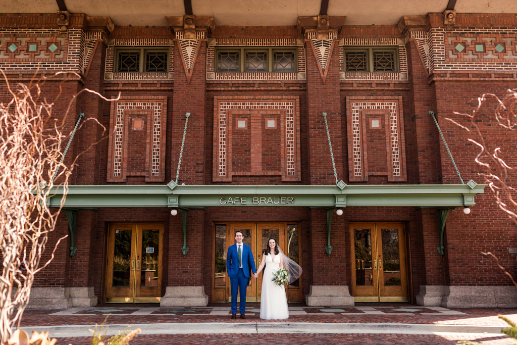 Cafe Brauer wedding photo of bride and groom holding hands outside venue in Lincoln Park