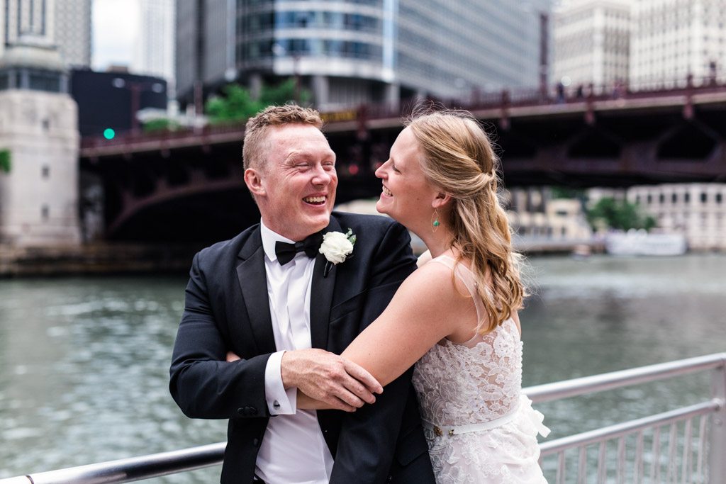 Bride and groom's joyful first look on Chicago Riverwalk before their Thalia Hall wedding