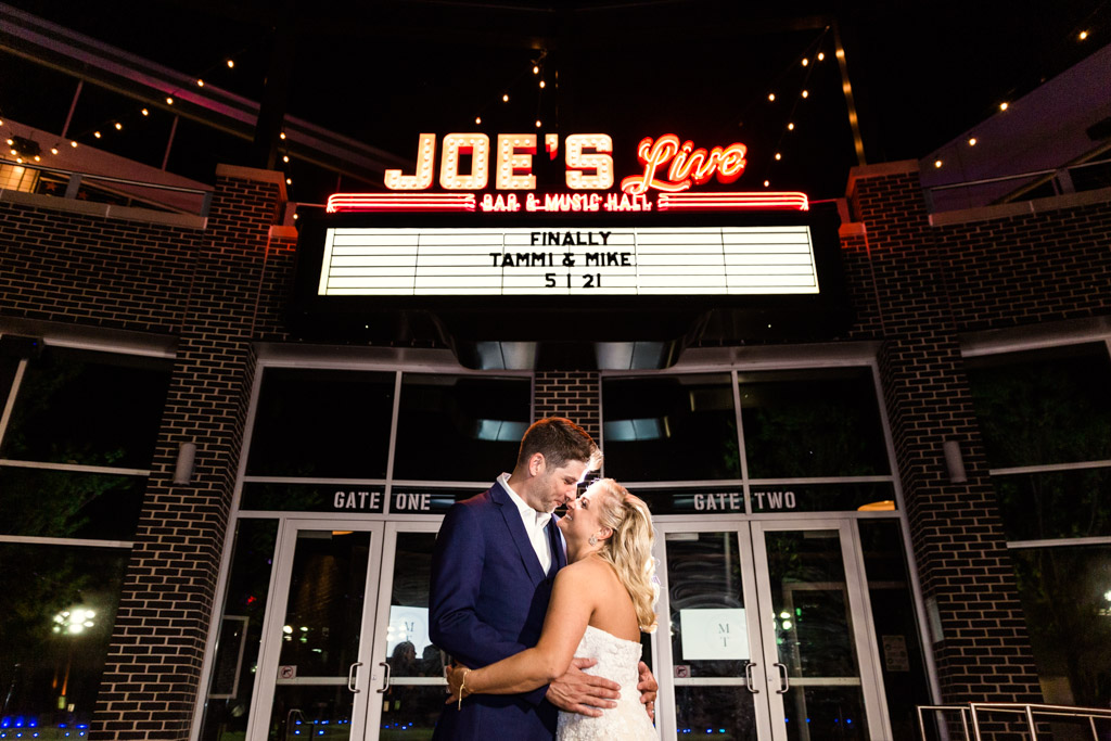 Epic night photo of bride and groom with their custom marquee at Joe's Live Rosemont wedding