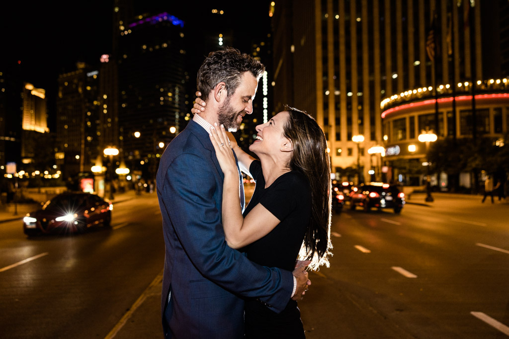 Romantic Chicago engagement photo at night with downtown city lights on Wacker Drive