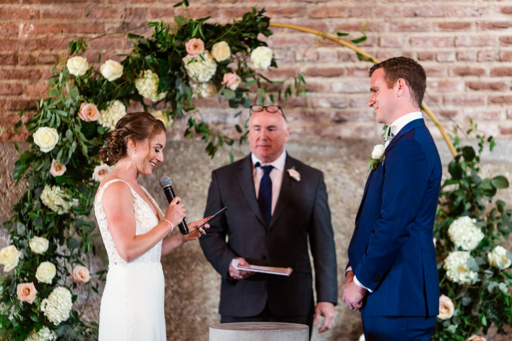 Bride and groom exchange vows during Gallery 1028 wedding ceremony by Emma Mullins Photography